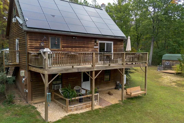a backyard of a house with table and chairs