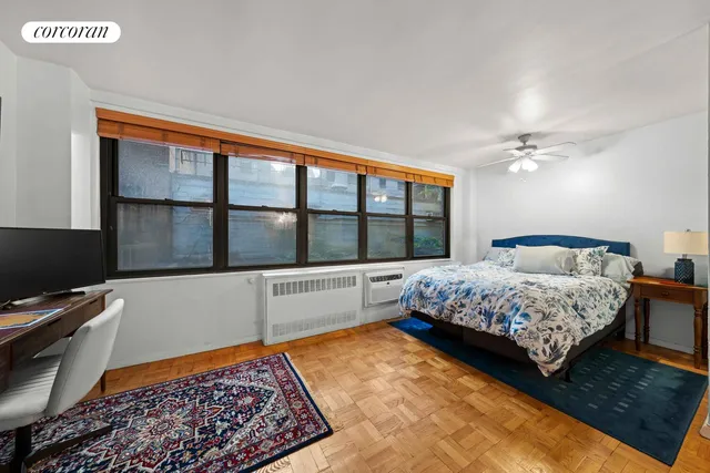 a bedroom with a bed a table and chairs