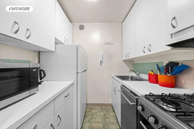 a work room with furniture and a flat screen tv