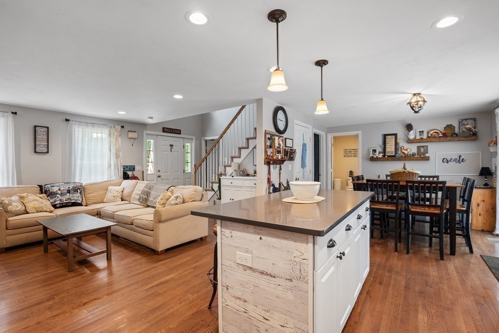 299 Allen Road Ashby, MA 01431 - Photo 11 of 26 a living room with furniture a wooden floor and a chandelier