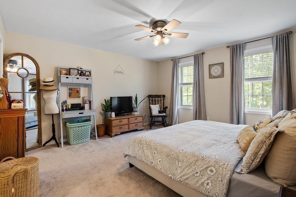 299 Allen Road Ashby, MA 01431 - Photo 16 of 26 a spacious bedroom with a bed and dresser with mirror