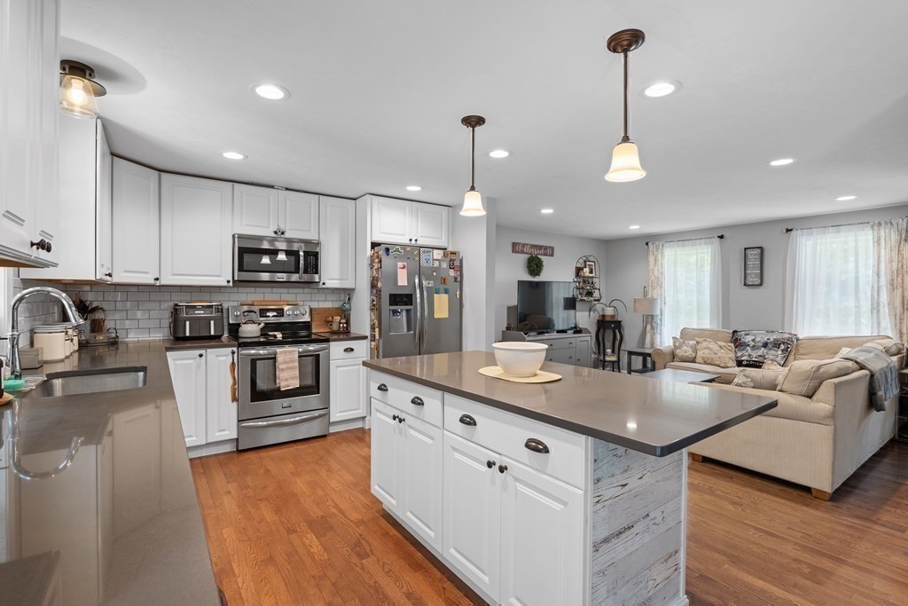 299 Allen Road Ashby, MA 01431 - Photo 8 of 26 a kitchen with stainless steel appliances granite countertop a sink refrigerator and cabinets