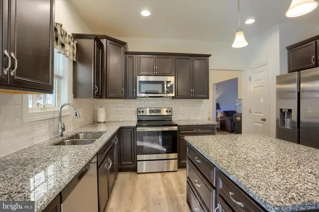 a living room with furniture flat screen tv and a couch