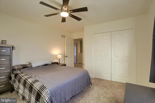 a bathroom with a granite countertop sink toilet and mirror