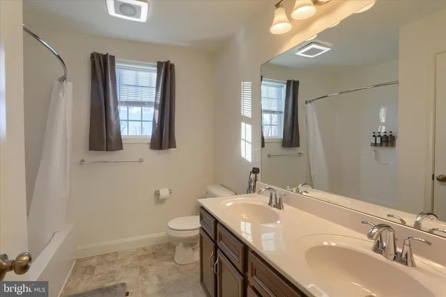 a large kitchen with lots of counter space and a wooden floor