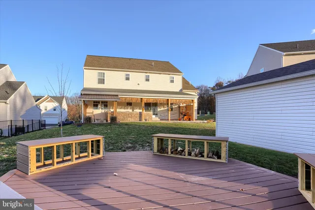 a view of a house with a yard and potted plants