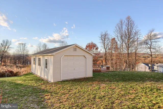 a view of a house with a yard and lake view