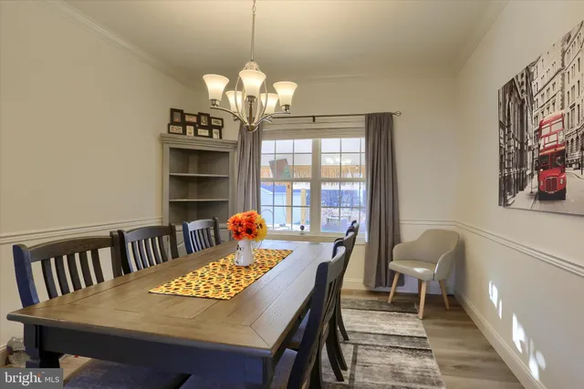 a view of a dining room with furniture wooden floor and chandelier