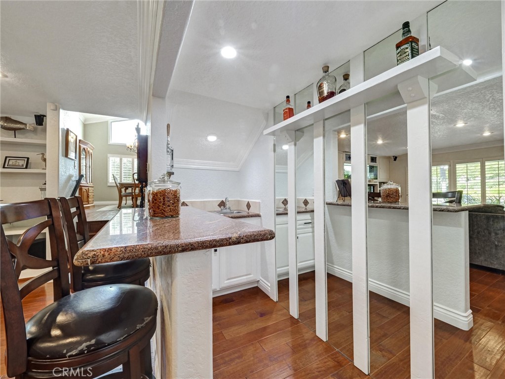 5831 Moonstone Avenue Rancho Cucamonga, CA 91701 - Photo 22 of 61 a kitchen with kitchen island a dining table chairs sink and cabinets
