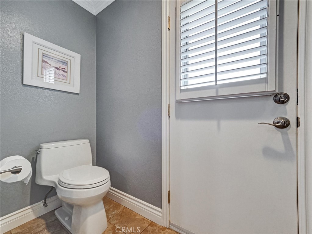 5831 Moonstone Avenue Rancho Cucamonga, CA 91701 - Photo 27 of 61 a white toilet sitting next to a bathroom sink