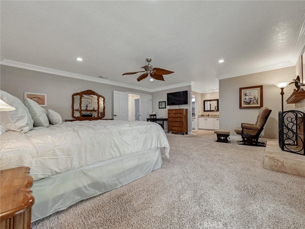 5831 Moonstone Avenue Rancho Cucamonga, CA 91701 - Photo 32 of 61 a spacious bedroom with a bed a couch and a chandelier