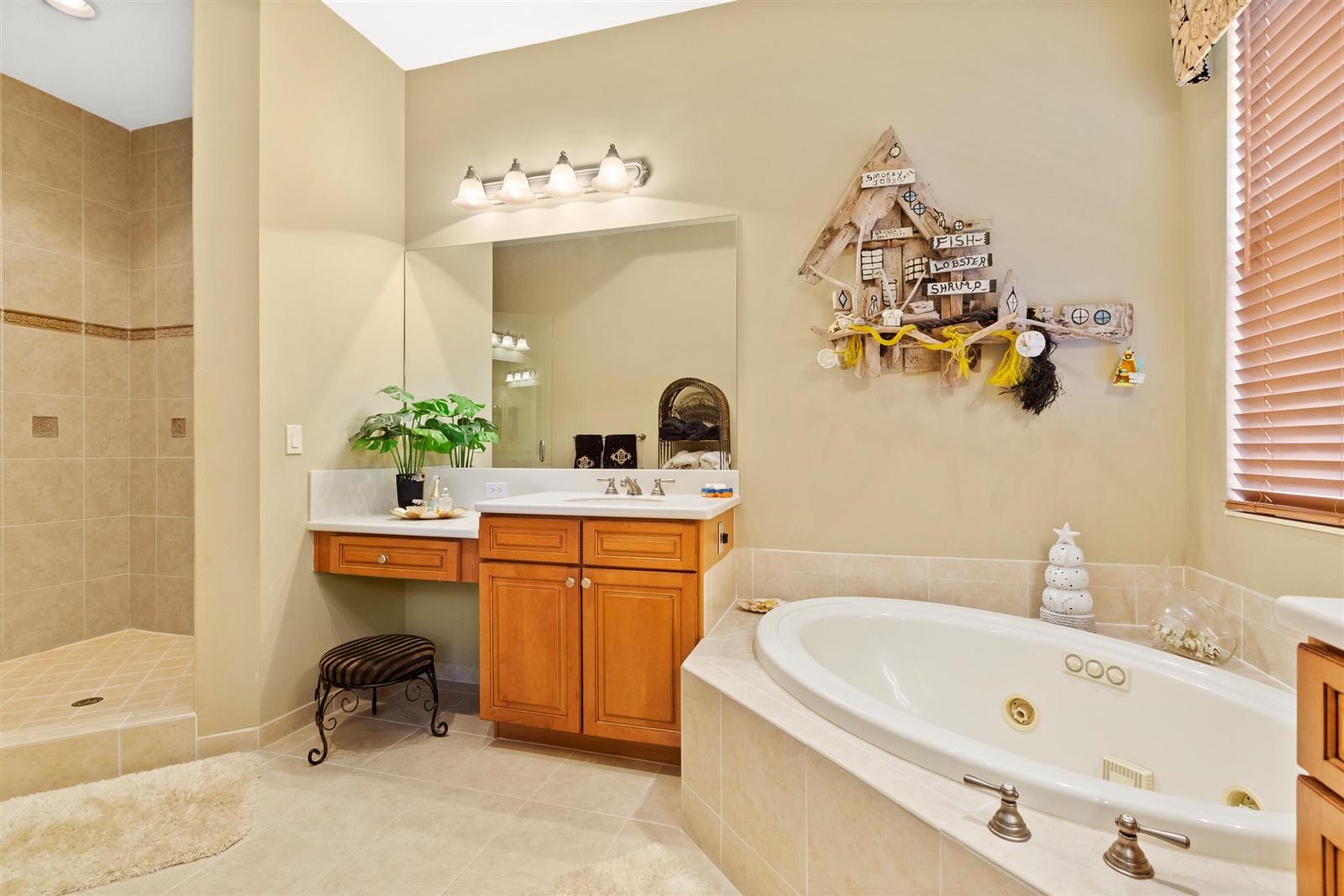 1000 North Us Highway, Unit 809 Jupiter, FL 33477 - Photo 15 of 30 a bathroom with a tub sink and mirror