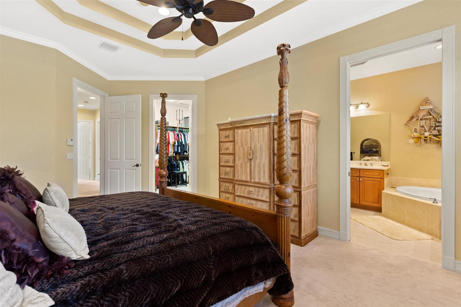 1000 North Us Highway, Unit 809 Jupiter, FL 33477 - Photo 17 of 30 a bedroom with a large bed and a chandelier