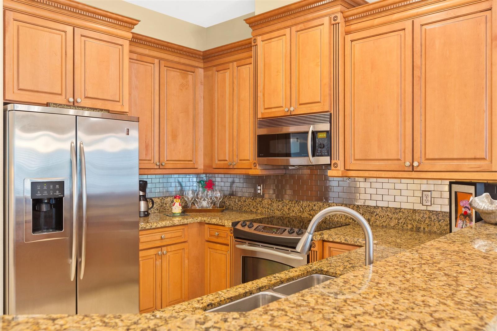 1000 North Us Highway, Unit 809 Jupiter, FL 33477 - Photo 9 of 30 a kitchen with stainless steel appliances granite countertop a refrigerator a stove a sink and a microwave