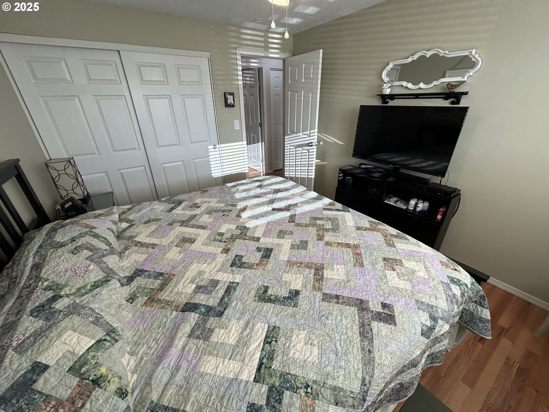 1753 Jansen Way Woodburn, OR 97071 - Photo 12 of 17 a bedroom with a bed and flat screen tv