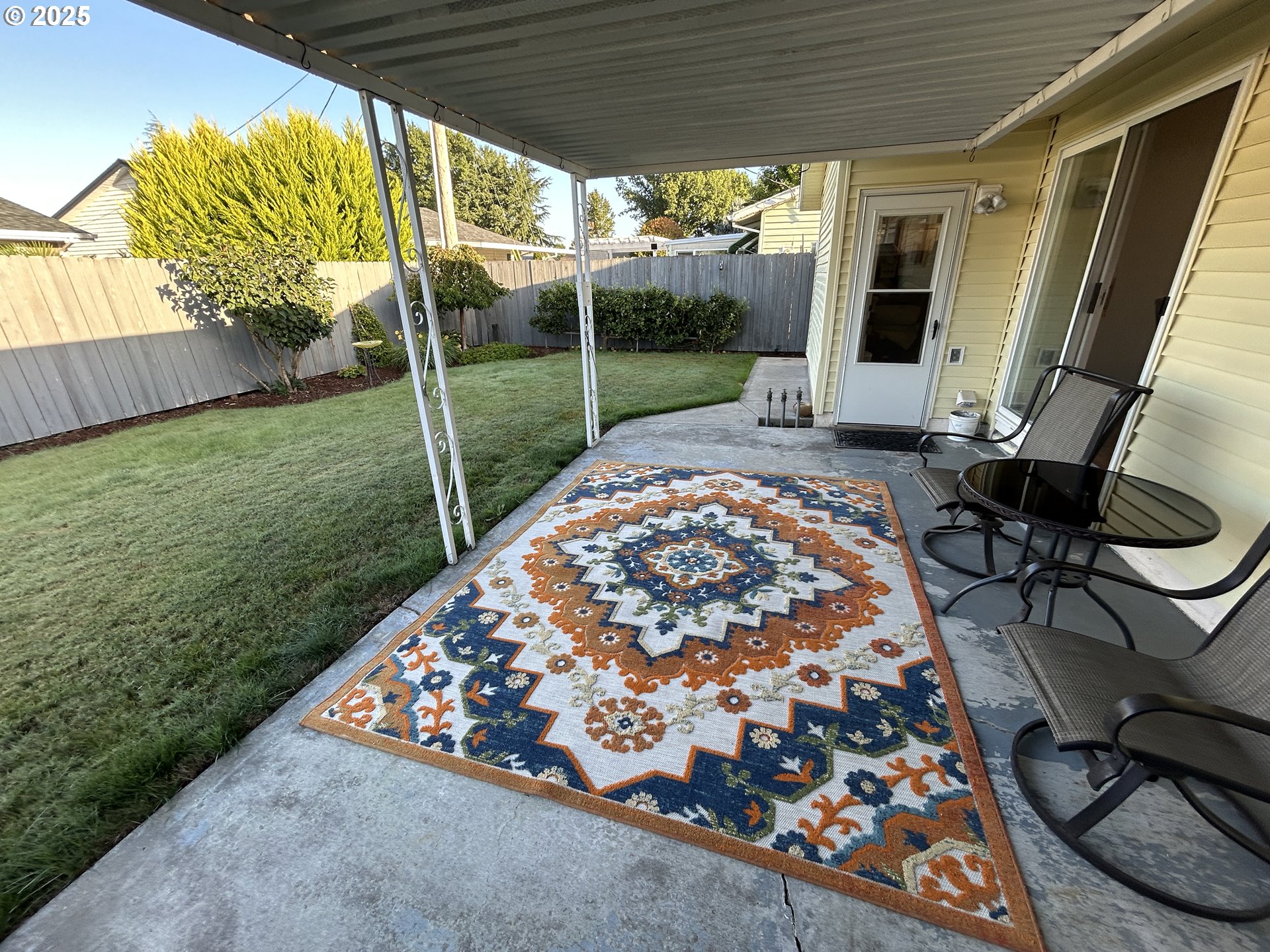 1753 Jansen Way Woodburn, OR 97071 - Photo 15 of 17 a view of a porch with furniture and garden