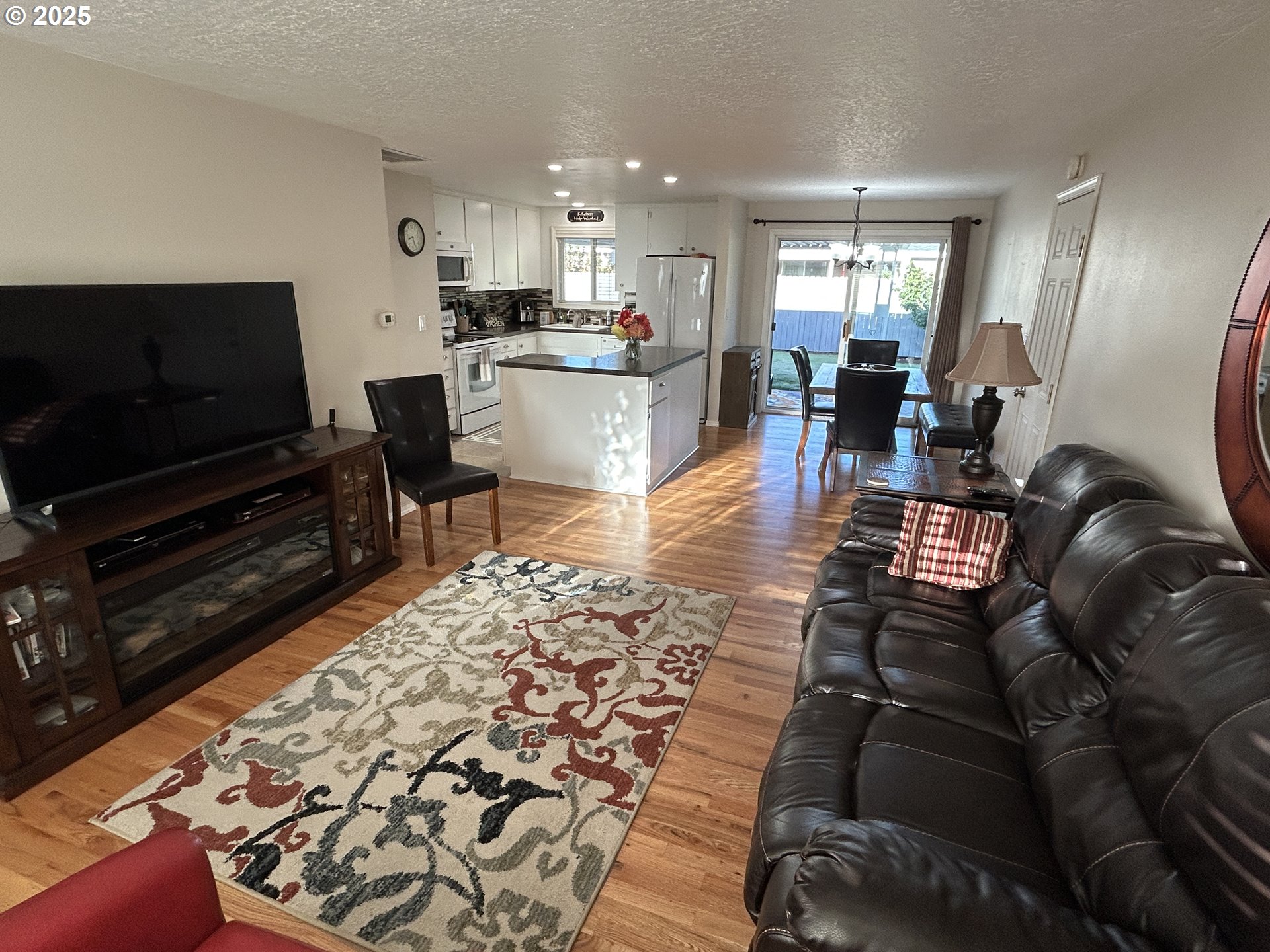 1753 Jansen Way Woodburn, OR 97071 - Photo 3 of 17 a living room with furniture and a flat screen tv
