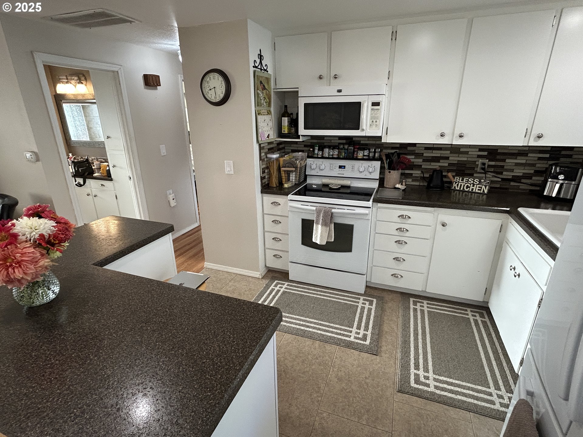 1753 Jansen Way Woodburn, OR 97071 - Photo 6 of 17 a kitchen with stainless steel appliances granite countertop a stove a sink and a microwave