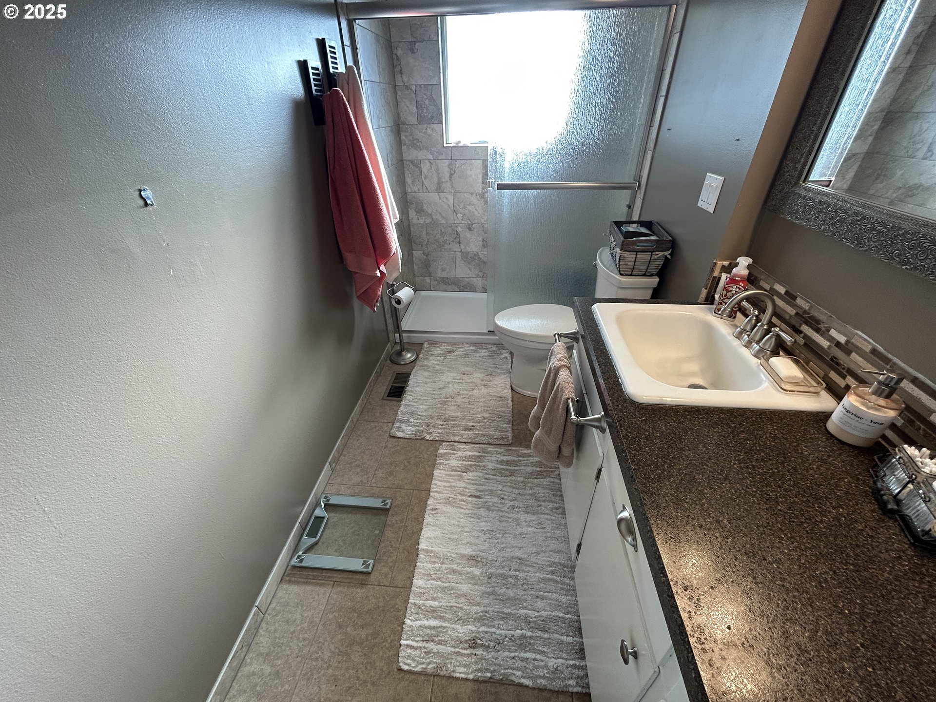 1753 Jansen Way Woodburn, OR 97071 - Photo 9 of 17 a bathroom with a sink and mirror with bathtub