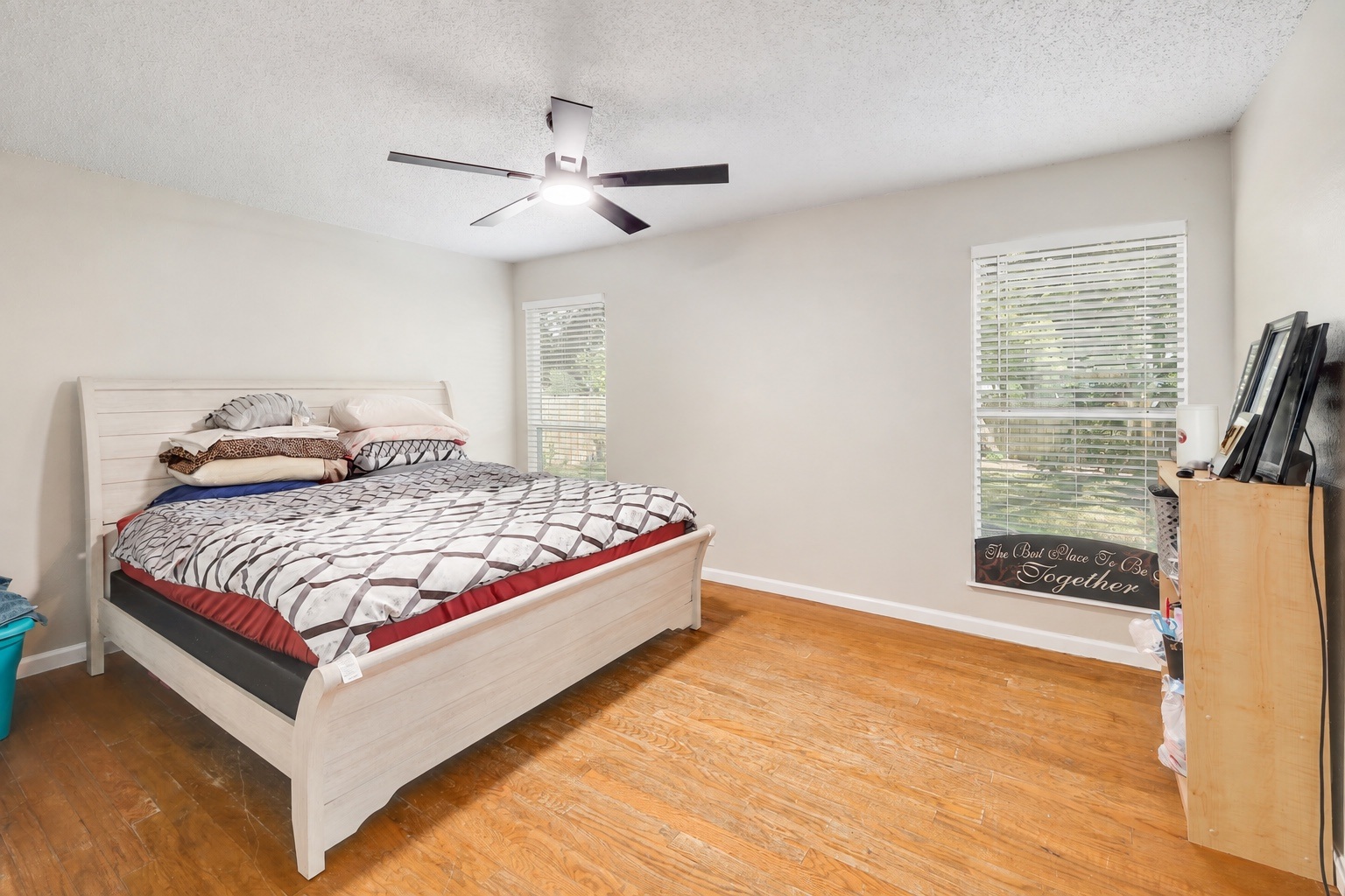 9906 Parliament House Road Austin, TX 78729 - Photo 11 of 33 Warm hardwood flooring and classic horizontal blinds define this welcoming bedroom space.