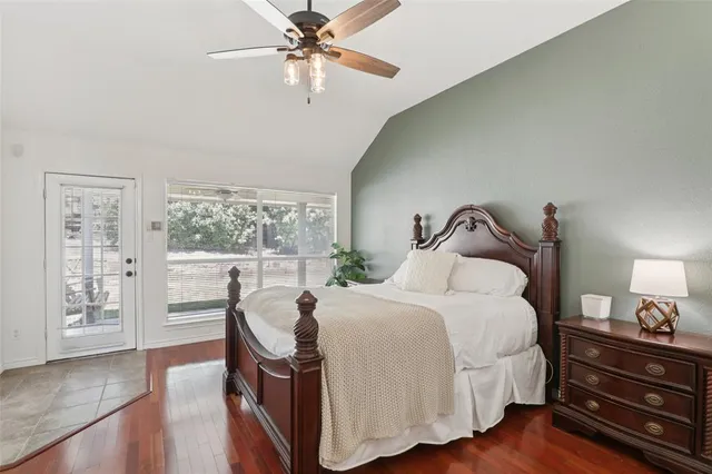 a bedroom with a bed and large windows