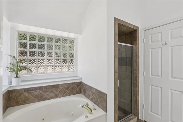 a bathroom with a bathtub and shower