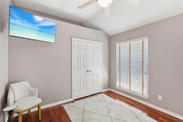 a view of room with window and a ceiling fan