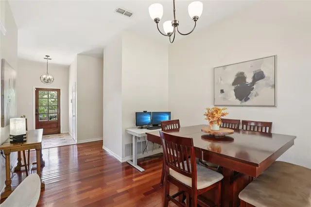 a view of a dining room with furniture wooden floor and a chandelier