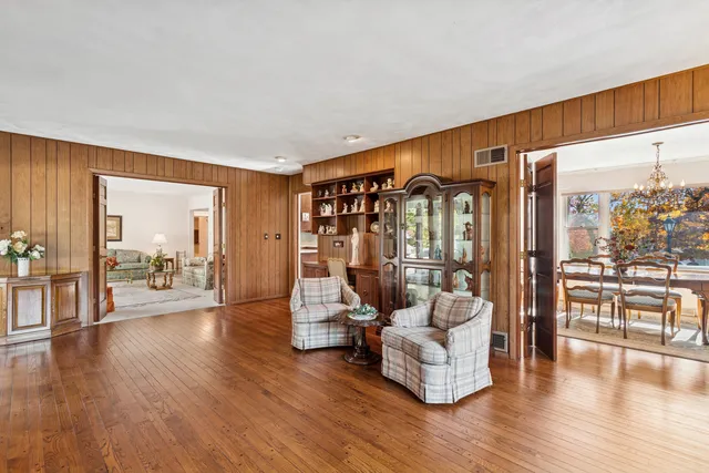 a bedroom with a bed and dresser with mirror