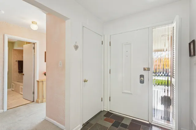 a bathroom with a granite countertop sink mirror and a toilet