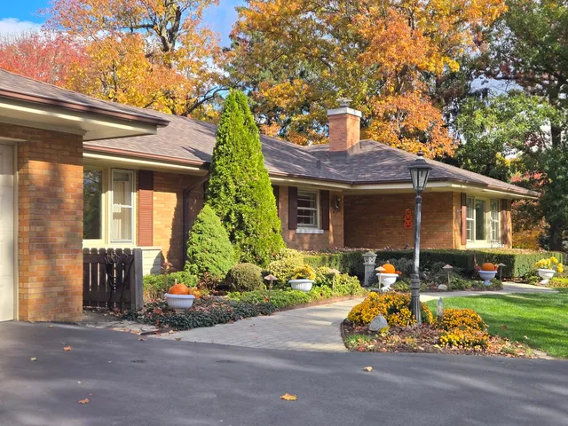 a front view of a house with a yard and outdoor seating