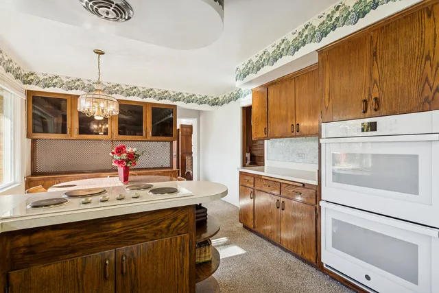a living room with furniture a large window and wooden floor
