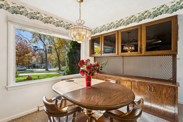 a living room with furniture potted plant and large windows