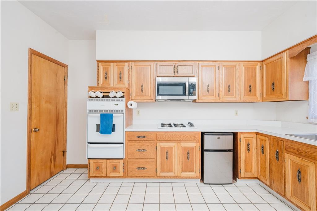 408 Indiana Road Creekside, PA 15732 - Photo 15 of 34 a kitchen with stainless steel appliances a white stove top oven and cabinets