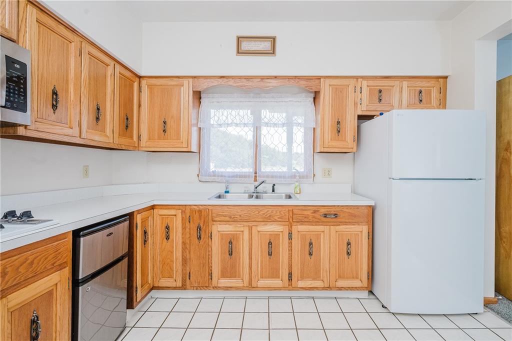 408 Indiana Road Creekside, PA 15732 - Photo 16 of 34 a kitchen with stainless steel appliances granite countertop a refrigerator sink and cabinets