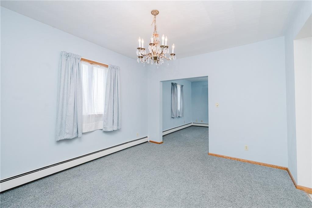 408 Indiana Road Creekside, PA 15732 - Photo 20 of 34 an empty room with chandelier fan and windows