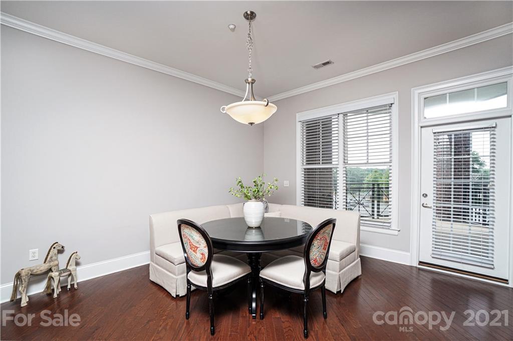 5425 Closeburn Road, Unit 103 Charlotte, NC 28210 - Photo 11 of 39 a dining room with furniture a window and a chandelier