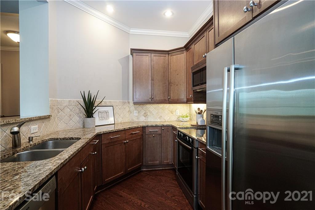 5425 Closeburn Road, Unit 103 Charlotte, NC 28210 - Photo 13 of 39 a kitchen with a sink stove and refrigerator