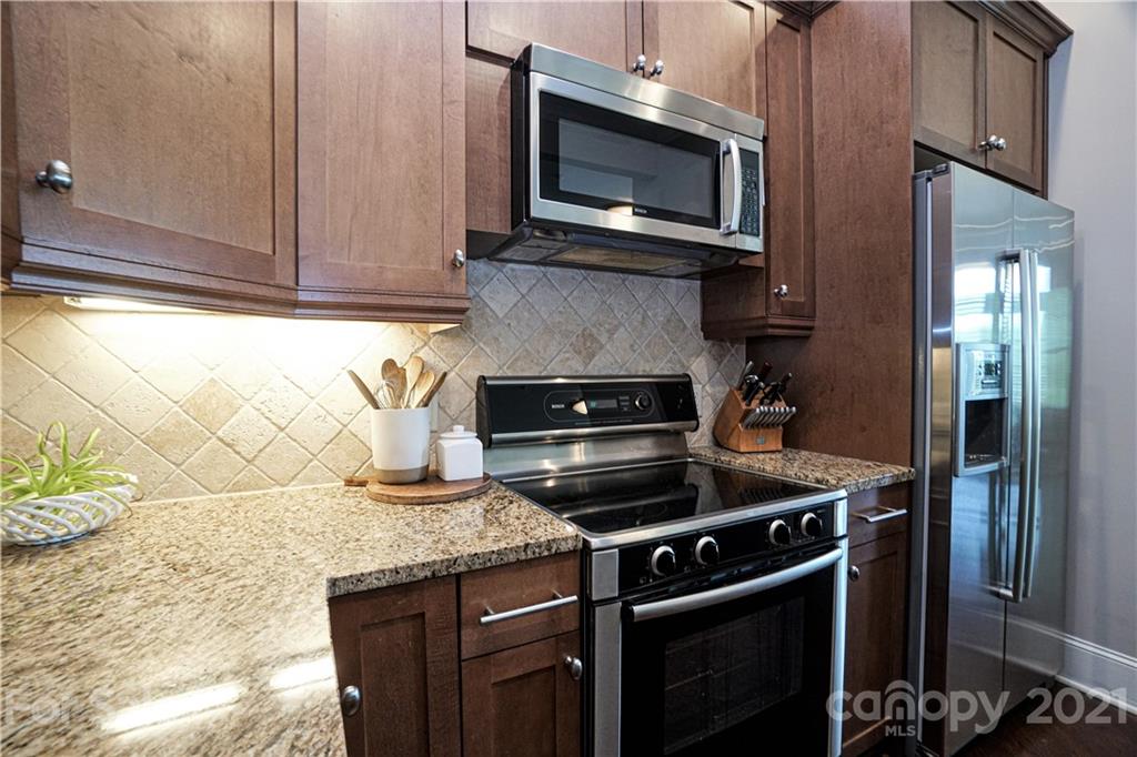 5425 Closeburn Road, Unit 103 Charlotte, NC 28210 - Photo 16 of 39 a kitchen with stainless steel appliances granite countertop a stove microwave and cabinets