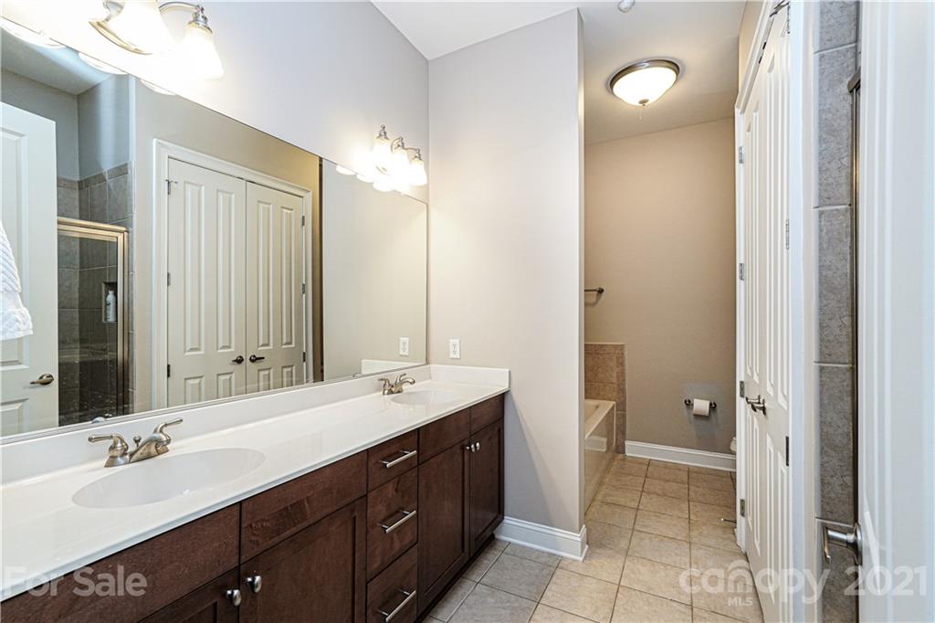 5425 Closeburn Road, Unit 103 Charlotte, NC 28210 - Photo 19 of 39 a bathroom with a double vanity sink mirror and double