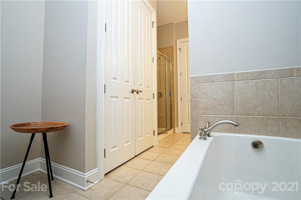 5425 Closeburn Road, Unit 103 Charlotte, NC 28210 - Photo 21 of 39 a bathroom with a bathtub and a shower