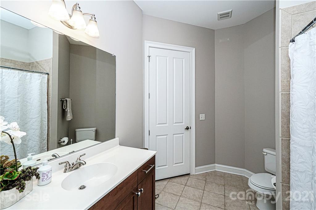 5425 Closeburn Road, Unit 103 Charlotte, NC 28210 - Photo 25 of 39 a bathroom with a sink a toilet and shower
