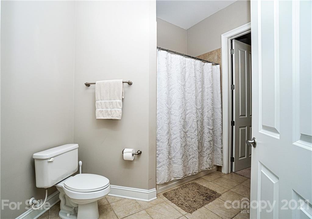 5425 Closeburn Road, Unit 103 Charlotte, NC 28210 - Photo 27 of 39 a bathroom with a toilet and a shower