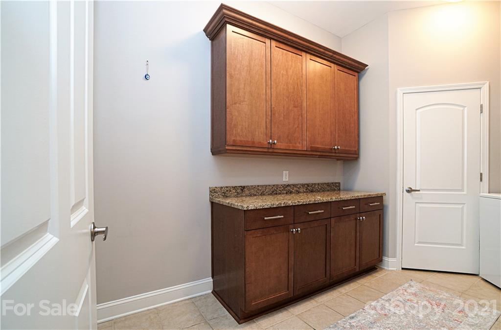 5425 Closeburn Road, Unit 103 Charlotte, NC 28210 - Photo 28 of 39 a kitchen with a stove and a cabinet