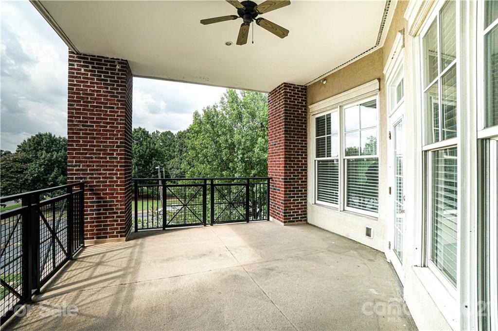 5425 Closeburn Road, Unit 103 Charlotte, NC 28210 - Photo 33 of 39 a view of a balcony with a floor to ceiling window and wooden floor