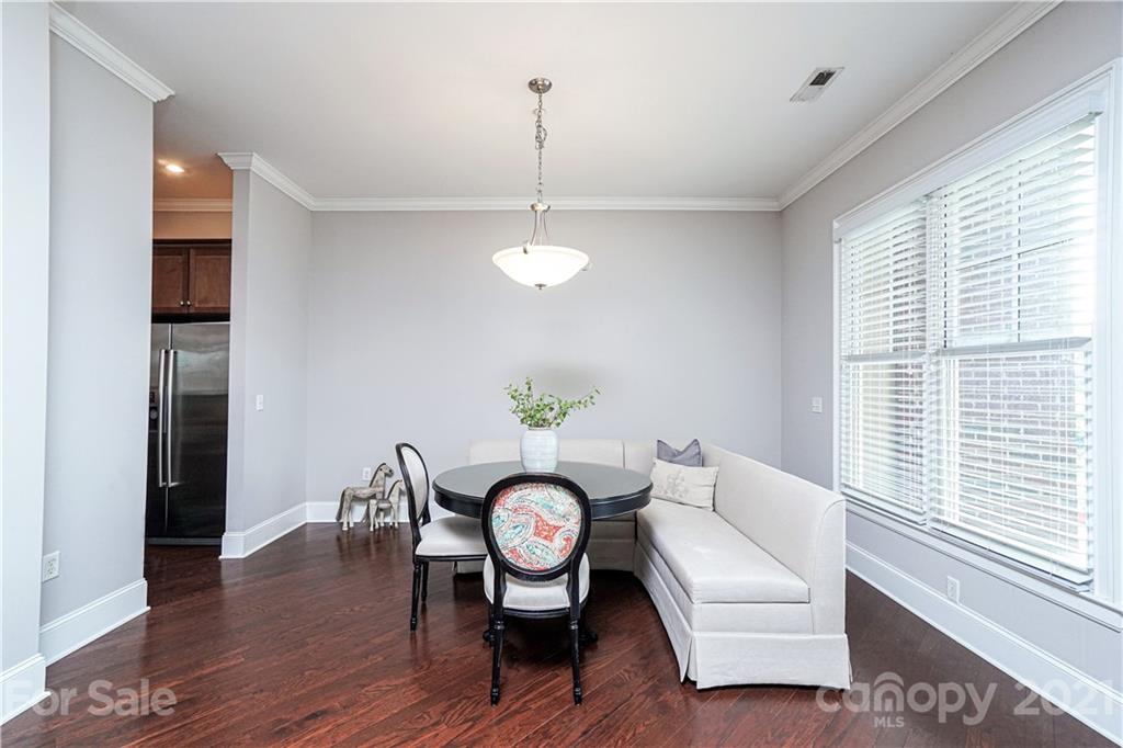 5425 Closeburn Road, Unit 103 Charlotte, NC 28210 - Photo 10 of 39 a view of a dining room with furniture window and wooden floor