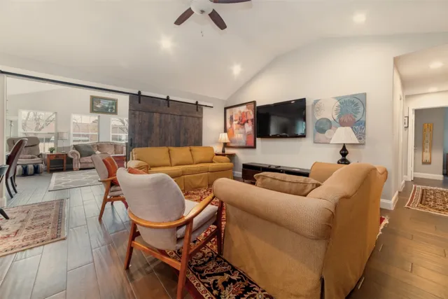 a living room with furniture and a ceiling fan