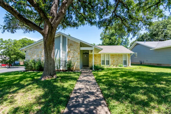 a view of a house with a yard and tree s