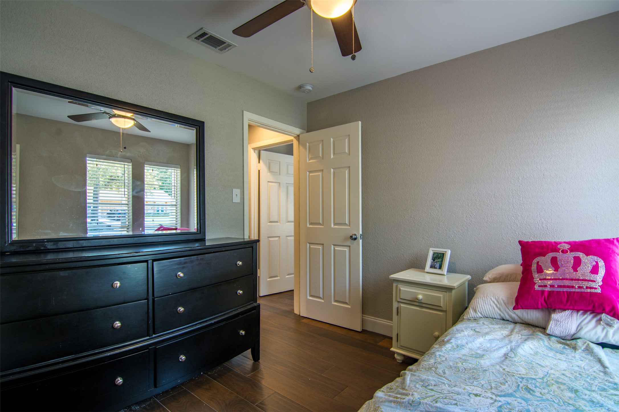 11705 Natrona Drive Austin, TX 78759 - Photo 31 of 35 Bedroom featuring dark wood-style flooring, a ceiling fan, and a textured wall