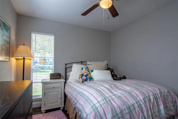 a bathroom with a granite countertop sink a toilet a mirror and shower